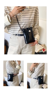 Close-up of black patent leather crossbody bag with a large white pearl buckle detail