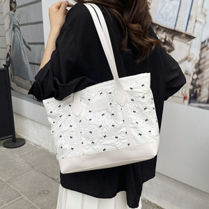 White quilted tote bag with black bow patterns for women summer casual commute