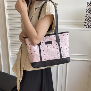 Pink pleated tote bag with black bow prints and handles for stylish summer commuting