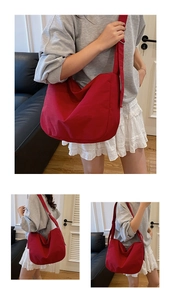 Detailed view of the large capacity red canvas hobo crossbody bag with adjustable strap