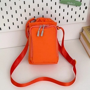 Mini orange nylon crossbody phone bag with drawstring closure and front zipper pocket