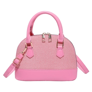Pink woven shell handbag with leather handles and detachable shoulder strap on white background