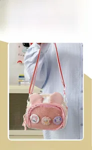 Detail view of pink and white bunny canvas bag with mesh pocket and badges