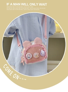 Detailed view of pink crossbody bag with bunny ears and clear mesh pocket for badges