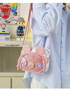 Detail of cute rabbit-themed crossbody bag with bunny ears and mesh pocket decoration