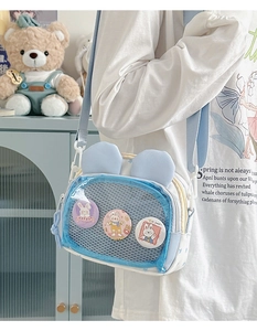 Detail of transparent crossbody bag with rabbit ears showing badge display window