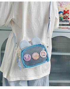 Close-up of light blue rabbit ear crossbody bag with a transparent badge window