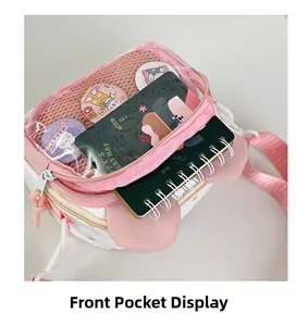 Detail of the transparent front pocket on a cute star-patterned crossbody bag
