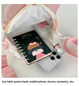 Detail view of pink crossbody bag interior with large capacity for laptop and water bottle