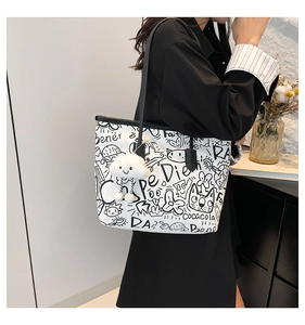 Fashionable graffiti tote bag side view with white cloud charm and artistic sketches