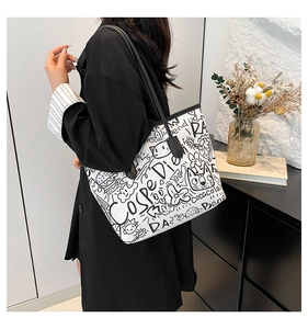 Detail view of large graffiti tote bag featuring cat prints and Coca-Cola street art style