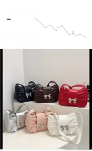 Close-up of pleated bow-shaped tote bags with metallic accents in six stylish colors