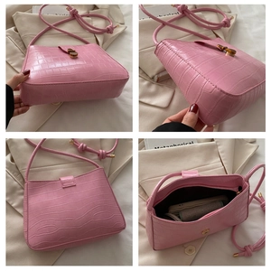 Detail view of pink crocodile pattern shoulder bag showing base, back and interior