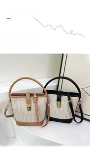 Detailed close-up of woven bucket bags with contrast leather trim and golden metal clasp