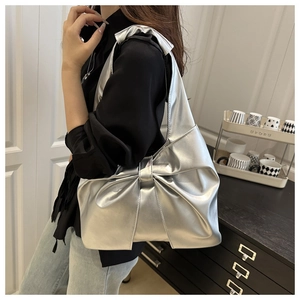 Detail of silver bow shoulder bag featuring metallic PU leather and sweet trendy design
