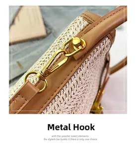 Close-up of golden metal hooks and woven straw texture on a stylish bucket bag