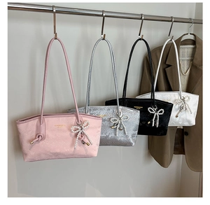 Close-up of sparkling sequin tote bags with pearl bow charms in four stylish colors