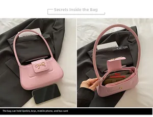 Internal view of pink leather baguette bag showing capacity for phone and lipstick