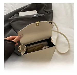 Internal view of cream crossbody bag showing space for phone, wallet and cosmetics
