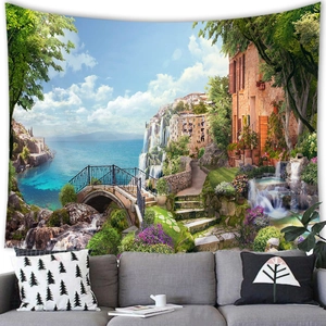 Mediterranean coastal town landscape tapestry wall hanging over a modern grey sofa