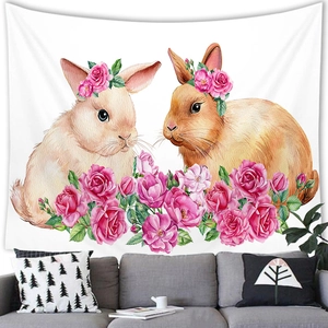 Easter watercolor bunny and pink rose tapestry hanging above a modern sofa in a living room