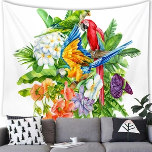 Tropical parrot tapestry with colorful birds and palm leaves hanging above a grey sofa