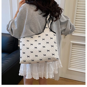 Sweet pleated canvas tote bag with black bow print and decorative shoulder straps