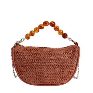Brown woven straw tote bag with amber acrylic bead handle and metal chain shoulder strap