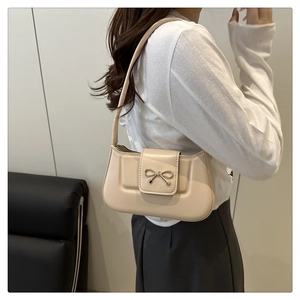 Détail du sac à bandoulière en cuir PU crème avec boucle en métal en forme de nœud