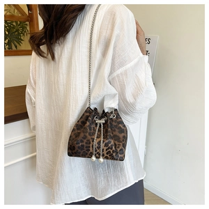 Chic leopard print bucket bag with silver chain strap and pearl drawstring detail