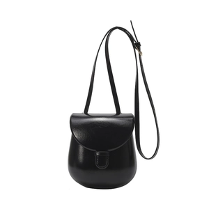 Classic black semi-round saddle bag with flap closure and adjustable slim strap