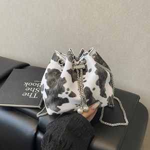 Mini drawstring bucket bag with cow print pattern, silver chain and pearl charms