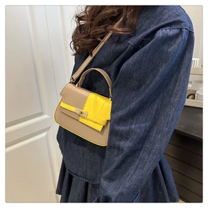 Detail of color-block Kelly bag in light coffee and bright yellow with metal lock
