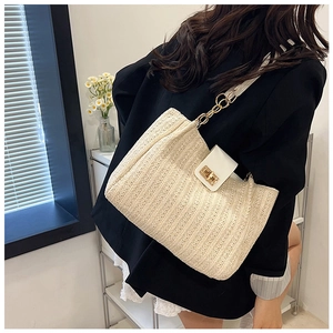 Détail de sac bandoulière crème tressé avec chaîne en métal doré et rabat en cuir chic
