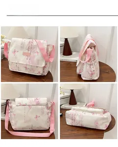 Detail view of pink and white butterfly print crossbody bag with multiple compartments