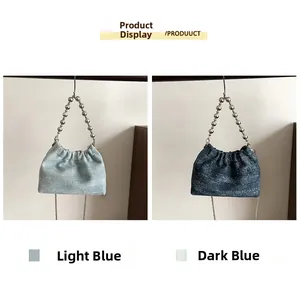 Detail of light and dark blue denim dumpling bags with pleated texture and bead chains