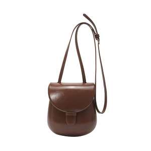Deep brown crossbody bag with glossy faux leather and vintage round flap design