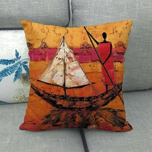 Detail of African oil painting pillow cover with artistic sunset scene on grey sofa