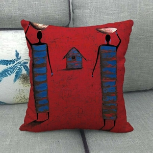 Detailed view of red African ethnic oil painting cushion cover on a grey fabric sofa