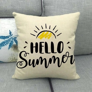 Detail of linen pillow cover with HELLO Summer text and sun print on grey sofa