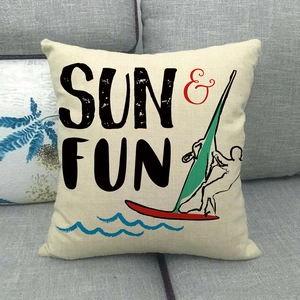 Linen throw pillow cover with Sun & Fun surfing print on a gray fabric sofa
