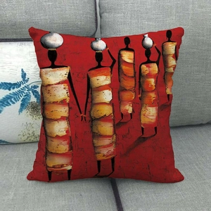 Detail of African ethnic style pillow cover featuring woman silhouettes on a gray sofa