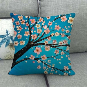 Close-up of linen pillow cover with floral tree oil painting on a blue background