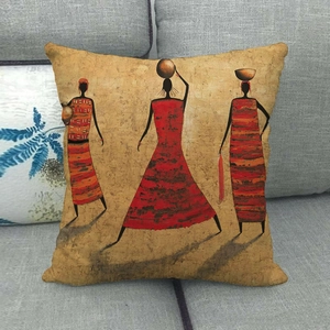 African ethnic art cushion cover featuring three women on a grey fabric sofa