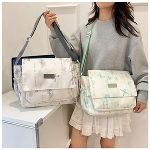 Detail of waterproof crossbody bag featuring butterfly print and elegant calligraphy art