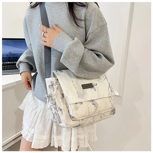 Detail of off-white butterfly crossbody bag featuring fashion label and side pocket