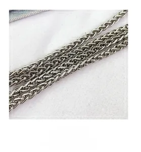 Close-up of durable silver woven metal chain strap for denim crossbody bags