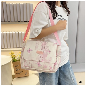 Detail of artistic butterfly print and leather label on white crossbody shoulder bag