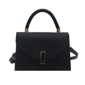 Elegant black crossbody bag with woven texture flap and gold hardware on white background