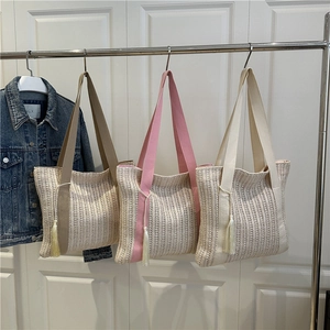 Straw woven shoulder tote bag with tassel charms in khaki, pink, and cream colors